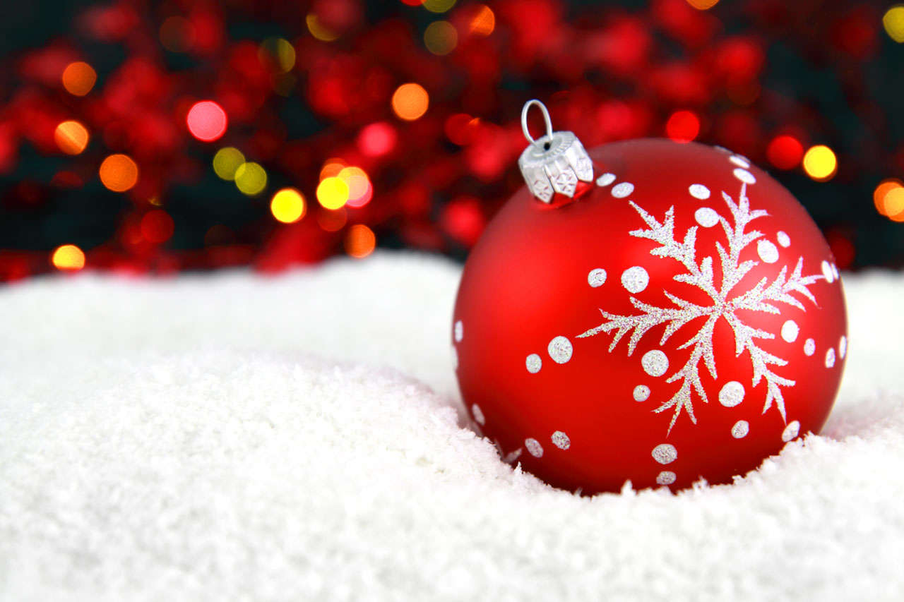 Red Christmas Ornament With Snow and Lights Photo